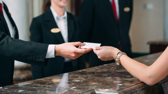Picture of guests getting key card in hotel